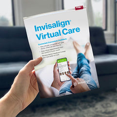 Person holding Invisalign cheek retractor for Invisalign virtual care