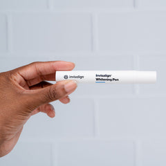 Person holding Invisalign whitening pen