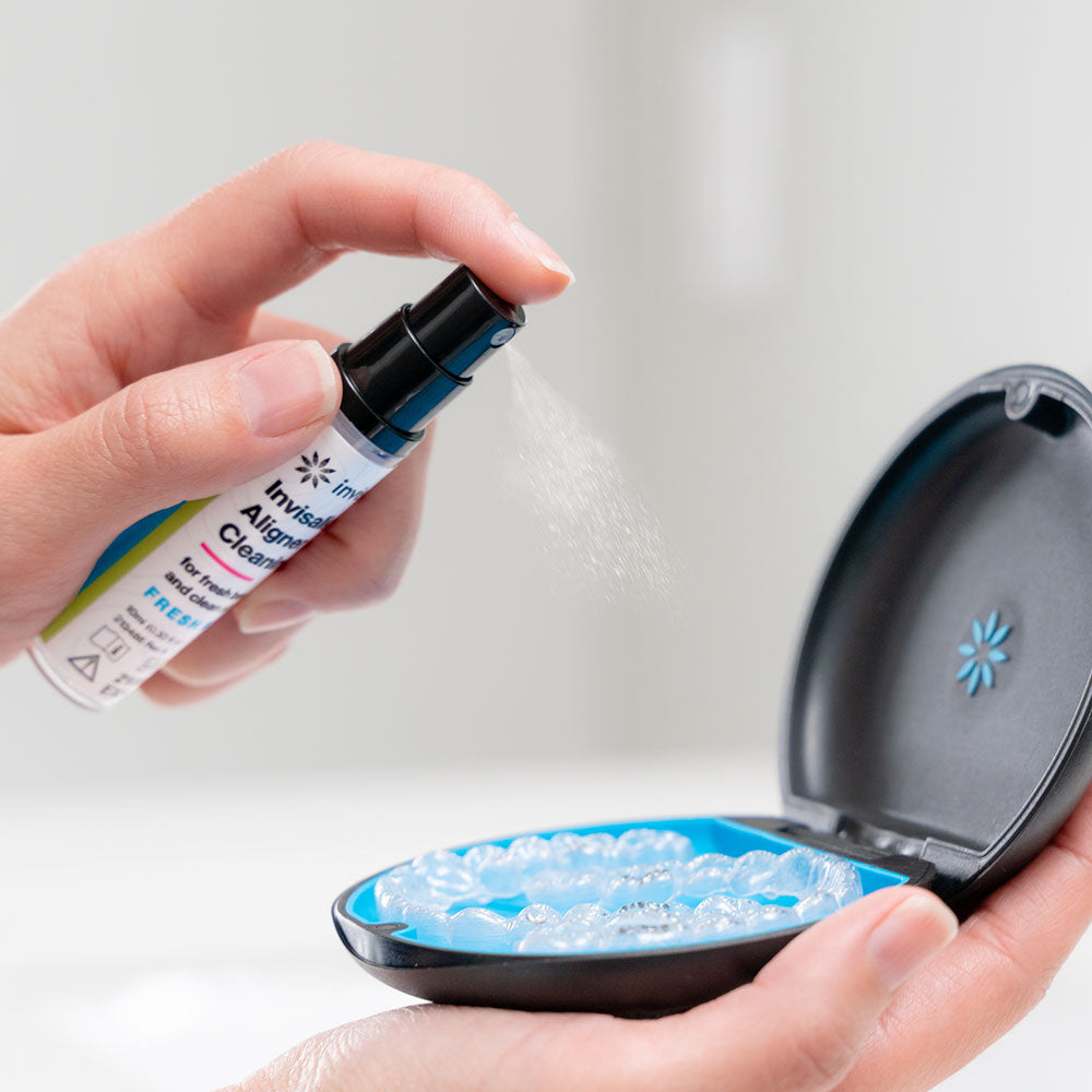 Person spraying aligners with Invisalign aligner cleaning spray