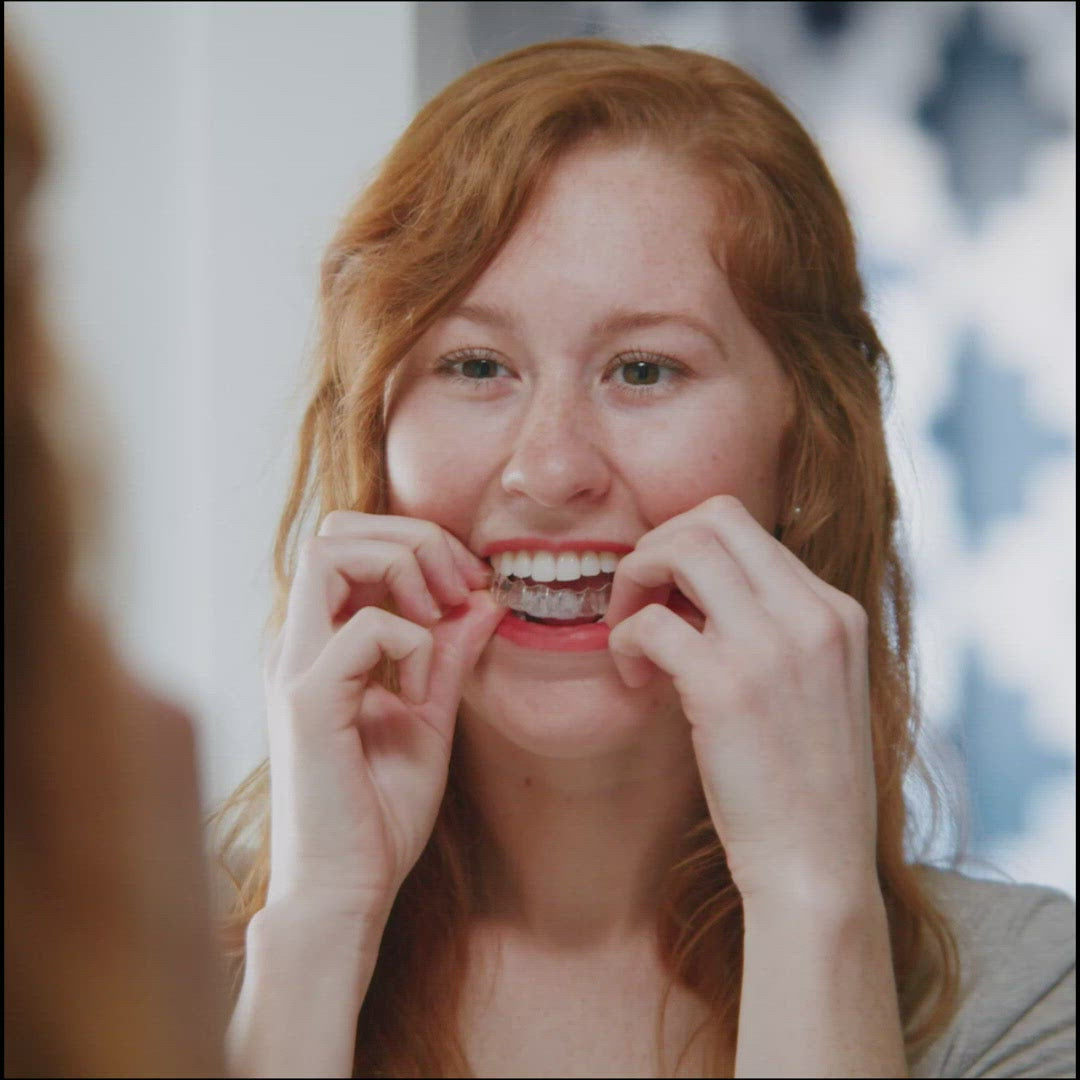 Invisalign™ Aligner Cleaning Foam 55ml andPerson using the Invisalign cleaning foam to clean aligners