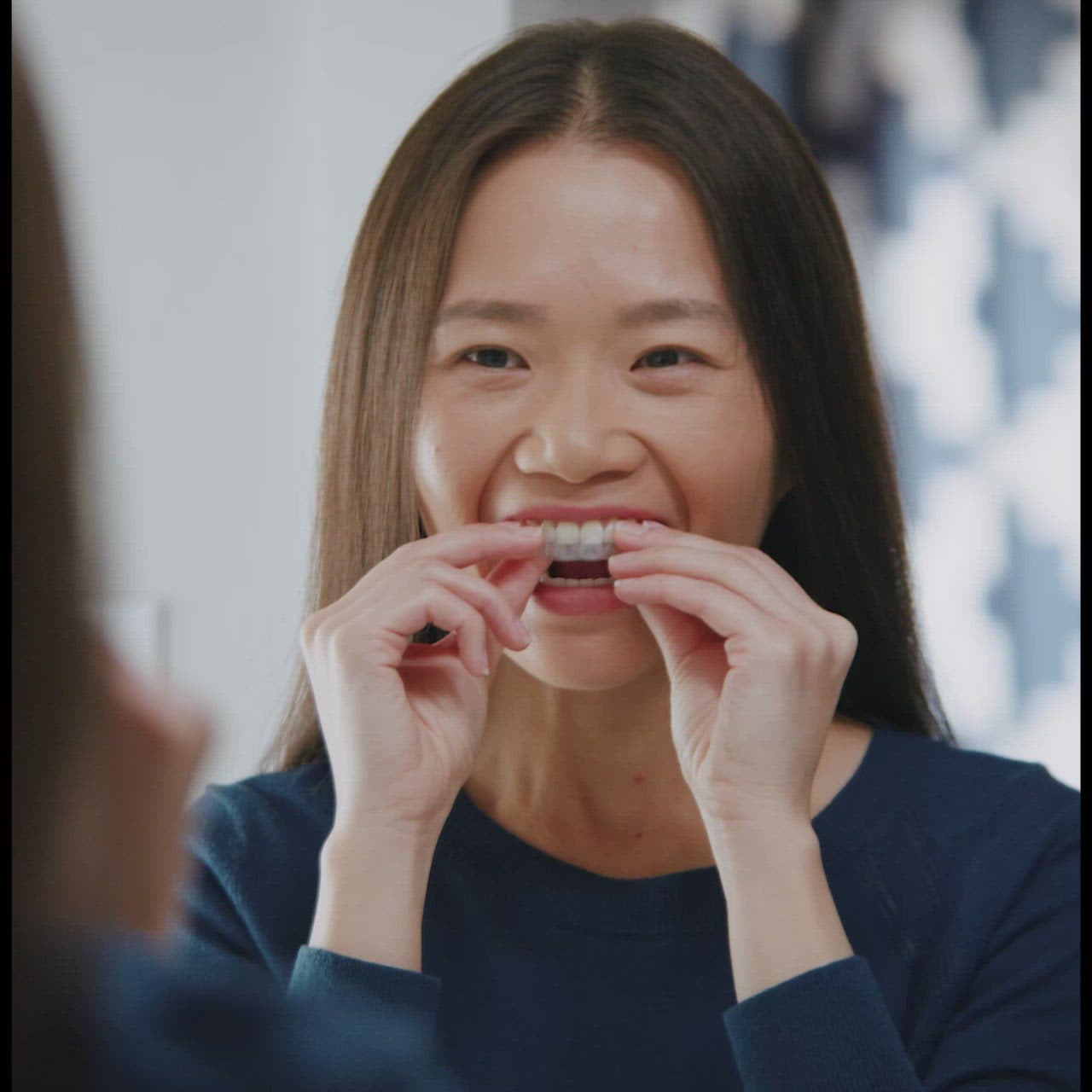 Person cleaning aligners with Invisalign cleaning crystals