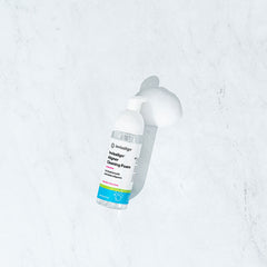 Bottle of Invisalign aligner cleaning foam with foam spilling