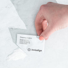 Hand holding packet of Invisalign cleaning crystals