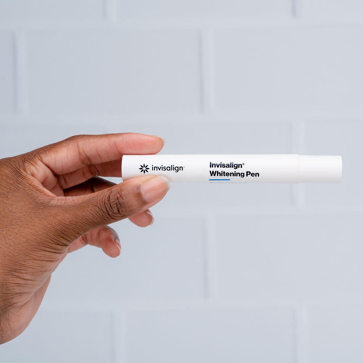Person holding Invisalign whitening pen
