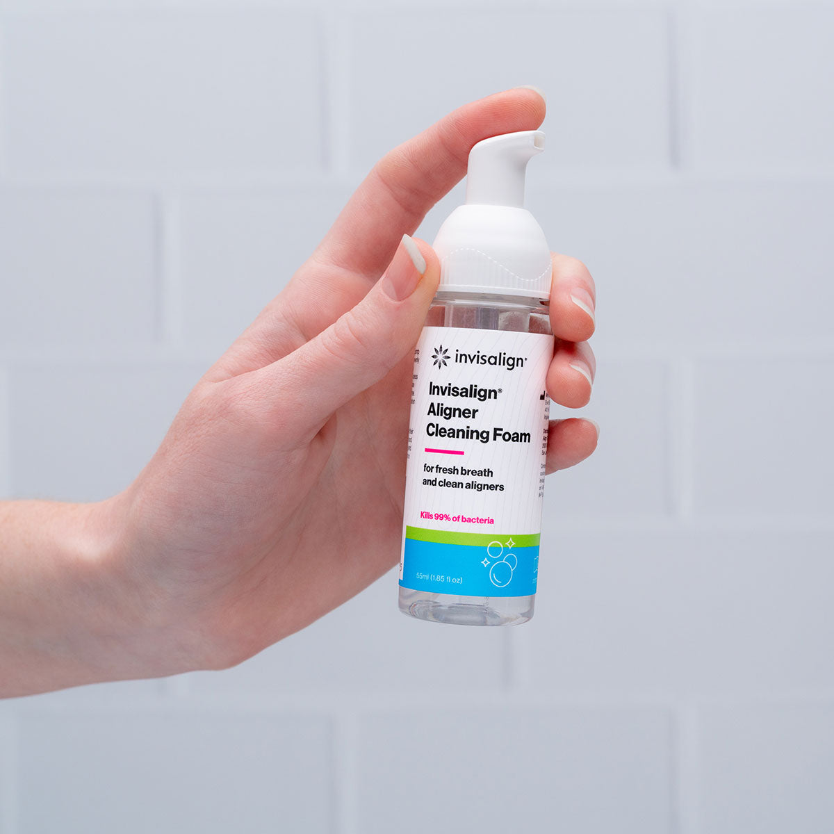 Invisalign™ Aligner Cleaning Foam 55ml bottle being held